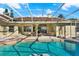 Inviting screened-in pool with brick accents, adjacent to the house with lounging area at 2230 Lake Crescent Ct, Windermere, FL 34786