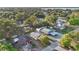Aerial view of homes surrounded by trees in a neighborhood with a lake in the distance at 226 Noxon St, Auburndale, FL 33823
