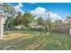 Expansive green backyard with mature trees and shrubs, providing privacy and natural beauty at 226 Noxon St, Auburndale, FL 33823