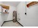 Basement with water heater, concrete walls, painted floors, storage shelf and utility hook bar at 226 Noxon St, Auburndale, FL 33823