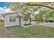 Well-maintained single-story home featuring a white brick facade and a convenient covered carport at 226 Noxon St, Auburndale, FL 33823