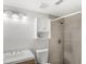 Bathroom features a shower stall, light fixture, medicine cabinet, toilet and sink at 2361 Carriage Run Rd, Kissimmee, FL 34741