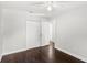 Bedroom with dark hardwood floors features a closet and a doorway to another room at 2361 Carriage Run Rd, Kissimmee, FL 34741