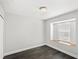Minimalist bedroom features dark wood floors and a sunlit window seat at 2361 Carriage Run Rd, Kissimmee, FL 34741