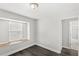 Bedroom features dark wood floors, sunlit window seat, and adjoining bathroom at 2361 Carriage Run Rd, Kissimmee, FL 34741