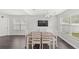 Open-concept dining area with dark wood floors, large windows, and a modern ceiling fan at 2361 Carriage Run Rd, Kissimmee, FL 34741