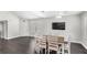 Spacious dining area with dark wood floors, a modern ceiling fan, and plenty of natural light at 2361 Carriage Run Rd, Kissimmee, FL 34741