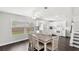 Bright kitchen featuring white cabinets, granite counters, and an adjacent dining area at 2361 Carriage Run Rd, Kissimmee, FL 34741