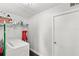 Bright laundry room with washer, dryer, shelving and storage space at 2361 Carriage Run Rd, Kissimmee, FL 34741