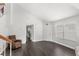 Bright living room featuring dark hardwood floors, staircase, and neutral paint at 2361 Carriage Run Rd, Kissimmee, FL 34741