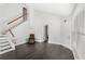 Bright living room featuring dark hardwood floors, staircase, and neutral paint at 2361 Carriage Run Rd, Kissimmee, FL 34741