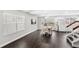 Open-concept living space with dark wood floors, natural light, and a view into the kitchen at 2361 Carriage Run Rd, Kissimmee, FL 34741