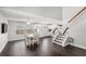 Bright open living space featuring modern flooring, a staircase, and an adjacent kitchen at 2361 Carriage Run Rd, Kissimmee, FL 34741