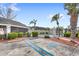 Community pool area features a fenced-in pool, landscaping, and parking at 2361 Carriage Run Rd, Kissimmee, FL 34741