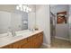 Bathroom with dual sinks, spacious countertop, and walk-in shower at 2631 Archfeld Blvd, Kissimmee, FL 34747