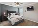 bedroom featuring carpet, dark-painted accent wall, and decorative Mickey Mouse bedding at 2631 Archfeld Blvd, Kissimmee, FL 34747