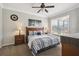 Bedroom with neutral tones, carpet, ceiling fan, and a large window offering natural light at 2631 Archfeld Blvd, Kissimmee, FL 34747