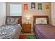 Nicely decorated bedroom featuring two beds, ceiling fan, and themed wall art at 2631 Archfeld Blvd, Kissimmee, FL 34747