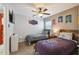 Nicely decorated bedroom featuring two beds, ceiling fan, and decorative wall art at 2631 Archfeld Blvd, Kissimmee, FL 34747