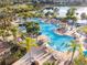 Aerial view of a resort-style pool with ample lounge seating and tropical landscaping at 2631 Archfeld Blvd, Kissimmee, FL 34747