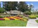 Windsor Hills community entrance with lush landscaping and colorful flower beds surrounding the prominent signage at 2631 Archfeld Blvd, Kissimmee, FL 34747
