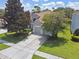 Charming single-Gathering home featuring a tile roof, manicured lawn, and attached two-car garage at 2631 Archfeld Blvd, Kissimmee, FL 34747