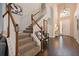 Open foyer with wood and carpeted stairs leading up to the second floor at 2631 Archfeld Blvd, Kissimmee, FL 34747
