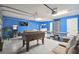 Spacious game room featuring a foosball table, ping pong table, and comfortable seating area at 2631 Archfeld Blvd, Kissimmee, FL 34747