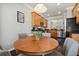 Cozy eat-in kitchen area with a round wooden table and four chairs, perfect for casual dining and gatherings at 2631 Archfeld Blvd, Kissimmee, FL 34747
