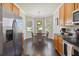 Bright kitchen featuring stainless steel appliances, a dining area, and a bay window, perfect for Gathering meals at 2631 Archfeld Blvd, Kissimmee, FL 34747