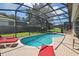 Enjoy the private screened pool with comfortable lounge chairs on the brick-paved pool deck at 2631 Archfeld Blvd, Kissimmee, FL 34747