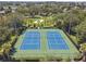 Aerial view of community tennis courts, meticulously maintained with lush green landscaping at 2631 Archfeld Blvd, Kissimmee, FL 34747
