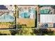 Aerial view of a backyard featuring a private screened-in pool and grassy area at 277 Sand Ridge Dr, Davenport, FL 33896