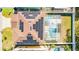 Aerial view of a backyard featuring a private screened-in pool with solar panels on roof at 277 Sand Ridge Dr, Davenport, FL 33896