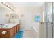 Bathroom featuring tiled floors, a shower-tub combo, and a long vanity with a large mirror and ample lighting at 277 Sand Ridge Dr, Davenport, FL 33896