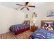 Comfortable bedroom featuring two twin beds, a ceiling fan, and hardwood floors at 277 Sand Ridge Dr, Davenport, FL 33896