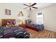 Charming bedroom featuring two twin beds, a ceiling fan, and hardwood floors at 277 Sand Ridge Dr, Davenport, FL 33896