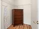 Spacious walk-in closet featuring hardwood floors, white shelving, and a chest of drawers at 277 Sand Ridge Dr, Davenport, FL 33896