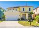 Charming two-story home with a two-car garage, well-manicured lawn and inviting curb appeal at 277 Sand Ridge Dr, Davenport, FL 33896