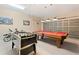 Spacious game room featuring a foosball table, pool table and access to the garage at 277 Sand Ridge Dr, Davenport, FL 33896
