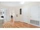 Hallway with hardwood floors, white walls, and access to the living room at 277 Sand Ridge Dr, Davenport, FL 33896
