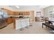 Spacious kitchen features an island with seating, stainless steel appliances, and granite countertops at 277 Sand Ridge Dr, Davenport, FL 33896