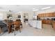 Open-concept kitchen with stainless steel appliances, breakfast bar and a nearby dining area at 277 Sand Ridge Dr, Davenport, FL 33896