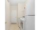 Bright laundry room with white appliances, a door to the outside, and plenty of space at 277 Sand Ridge Dr, Davenport, FL 33896