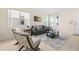 Comfortable living room featuring a gray sofa, tile flooring, and natural light from multiple windows at 277 Sand Ridge Dr, Davenport, FL 33896