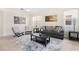 Comfortable living room with gray sofa, patterned pillows, unique chairs, neutral walls and tile flooring at 277 Sand Ridge Dr, Davenport, FL 33896