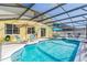 Private screened-in pool with a hot tub, various seating, and a covered lanai for outdoor enjoyment at 277 Sand Ridge Dr, Davenport, FL 33896