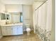 Bathroom featuring a tiled floor, vanity, toilet, and shower with a decorative shower curtain at 2956 Lucayan Harbour Cir # 108, Kissimmee, FL 34746