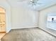 Bright bedroom featuring neutral carpet, a ceiling fan, and an ensuite bathroom at 2956 Lucayan Harbour Cir # 108, Kissimmee, FL 34746