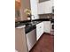 Spacious kitchen with stainless steel dishwasher, appliances, black countertops, and ample storage at 2956 Lucayan Harbour Cir # 108, Kissimmee, FL 34746